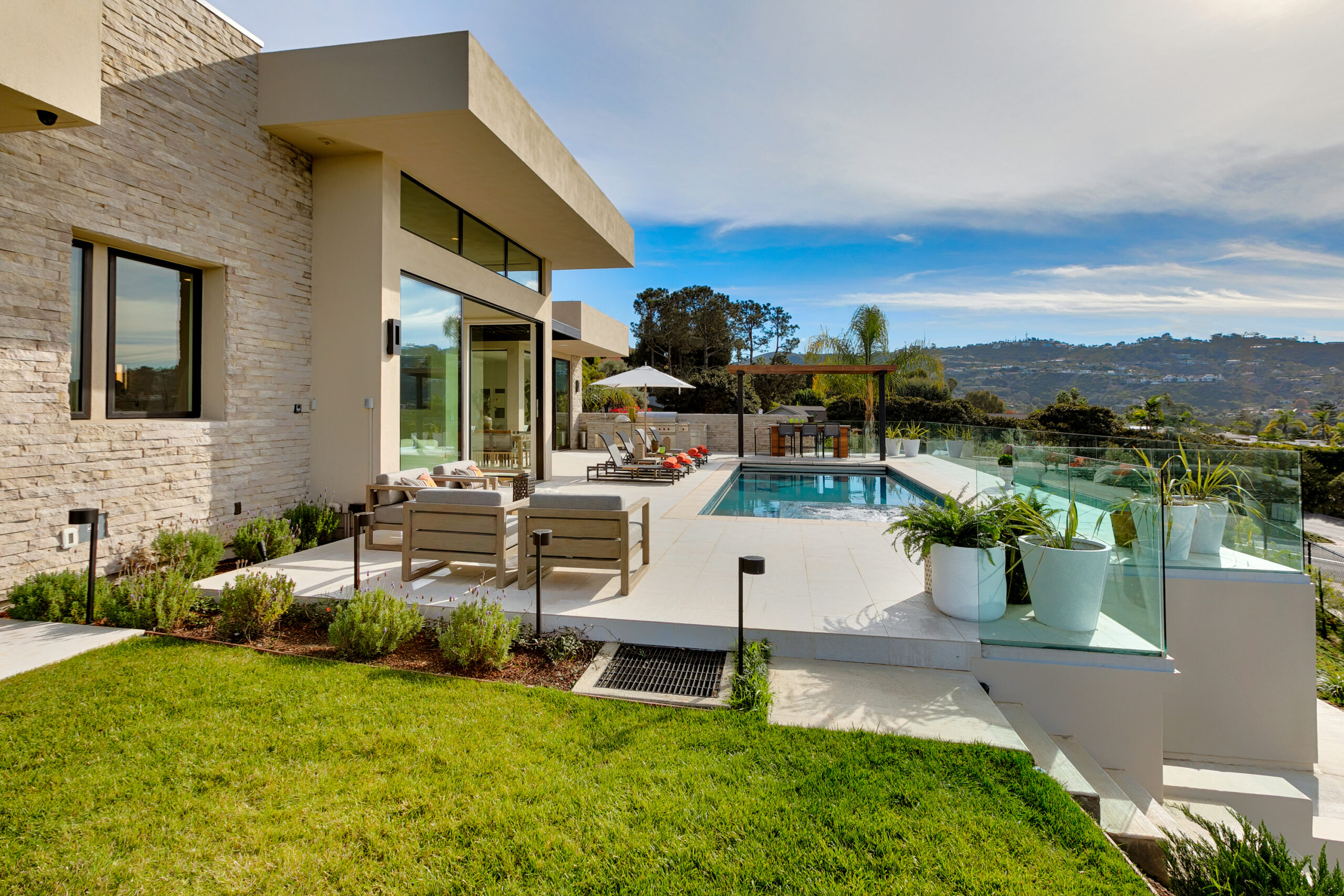 A GDC Construction custom home in Encinitas with a pool terrace overlooking the hills